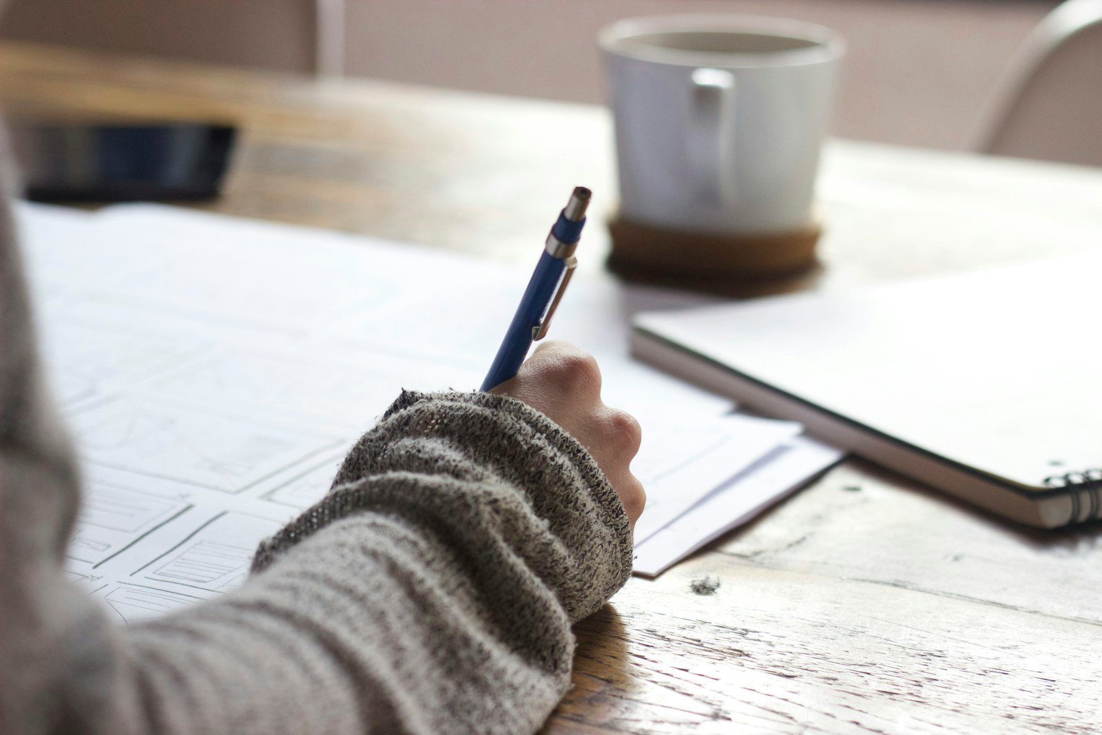 Open notebook with outline notes and pen